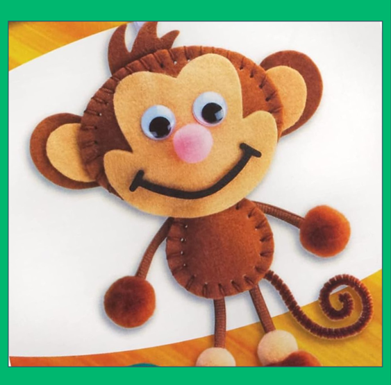 Felt craft monkey with googly eyes and a broad stitched smile on a white and yellow background.